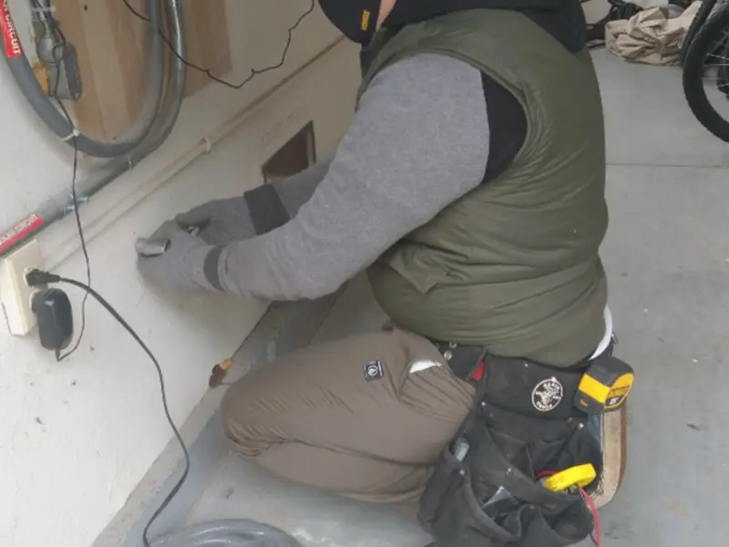 Electrician performing outlet wiring in a Pasadena garage